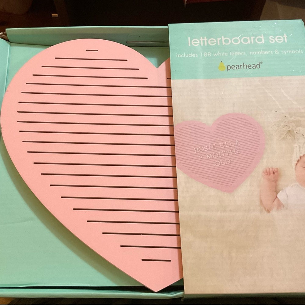 Pearhead light pink heart shaped letter board. White letters to write messages.